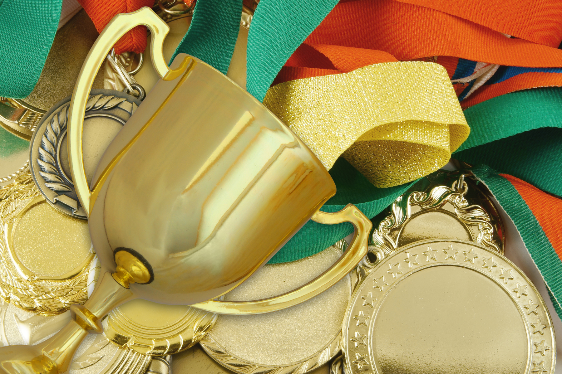 Golden trophy cup on medals background